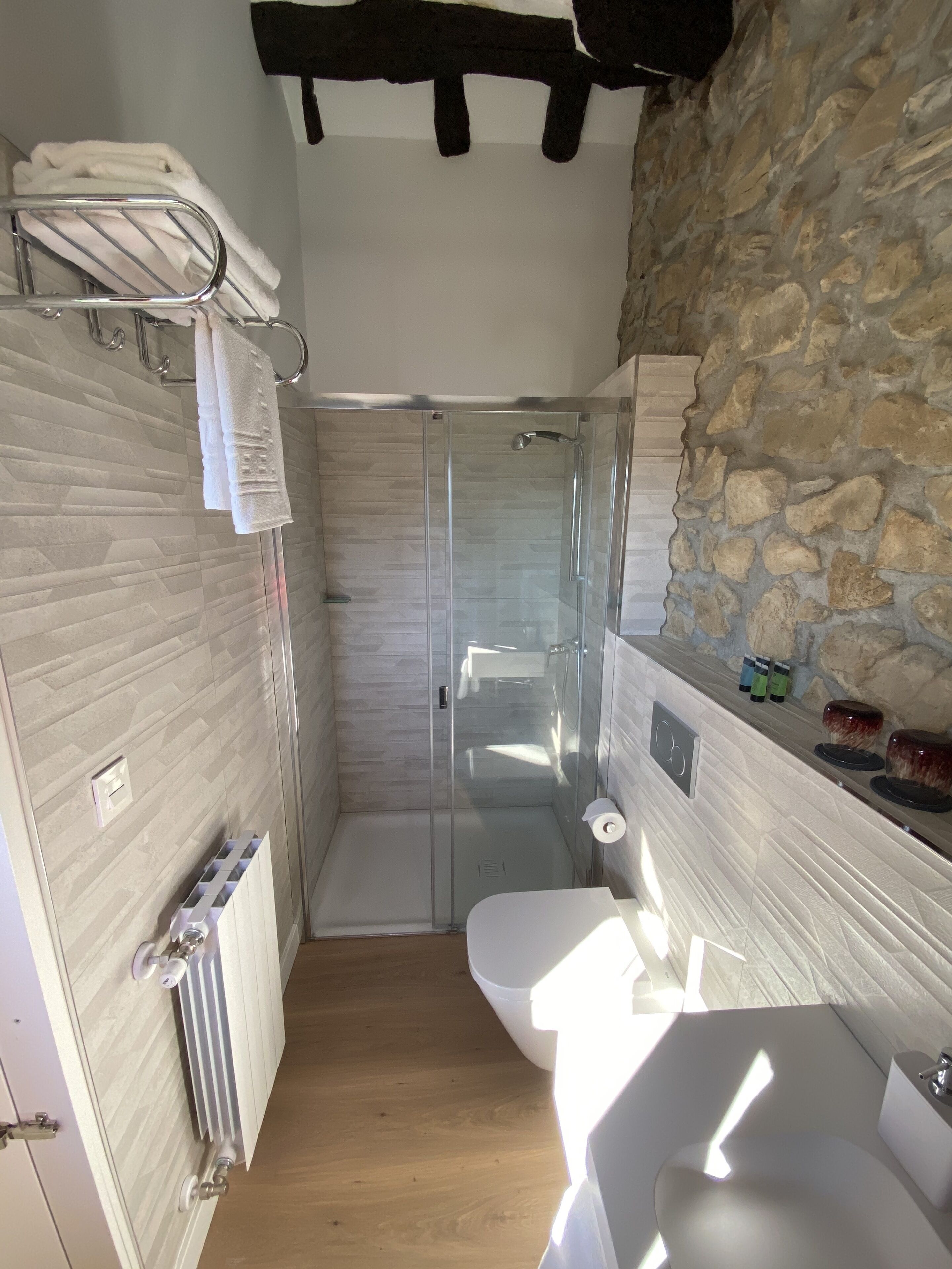 A bathroom with a shower, toilet, and sink.