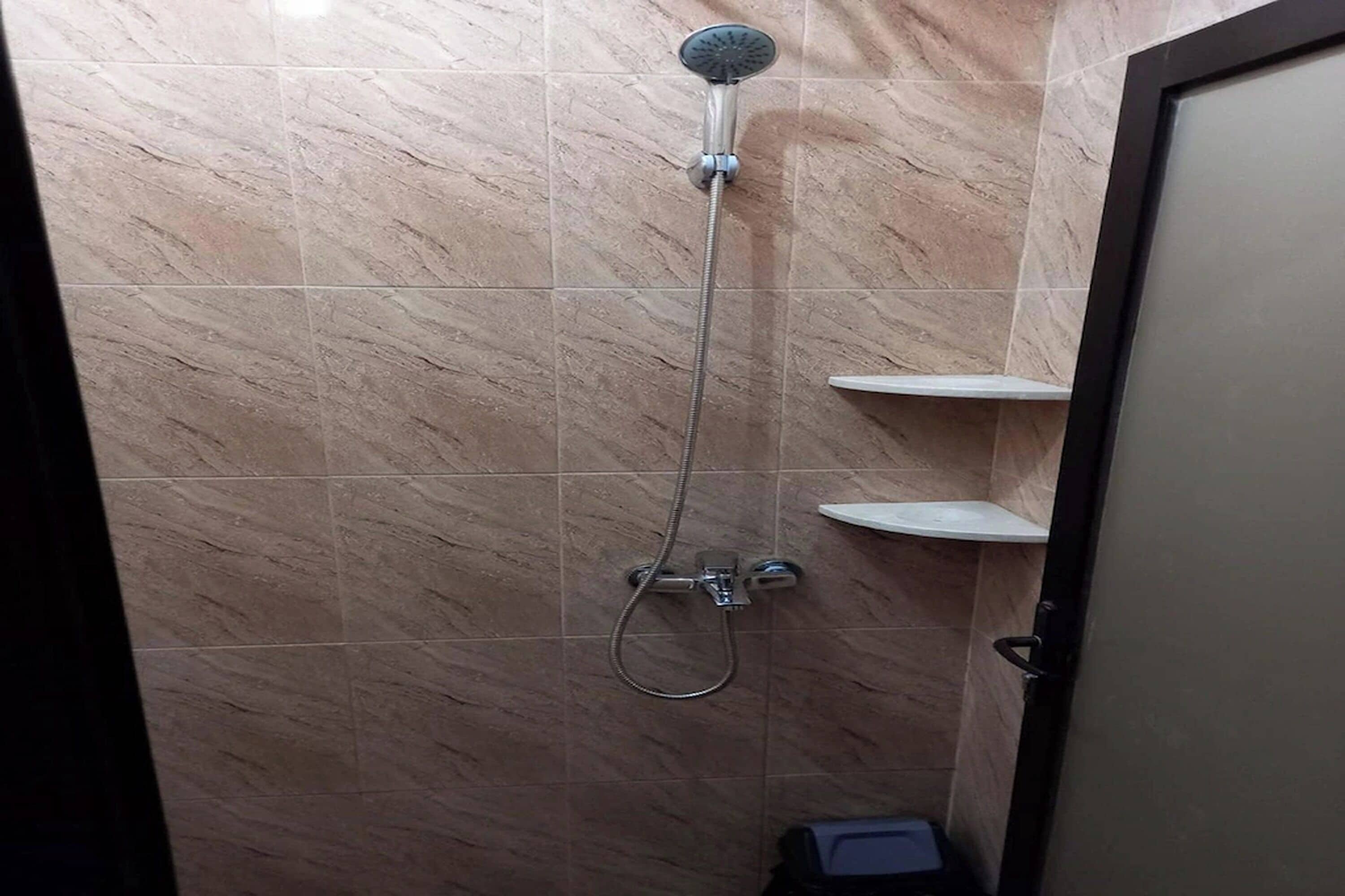 A bathroom with a shower, a sink, and a toilet.