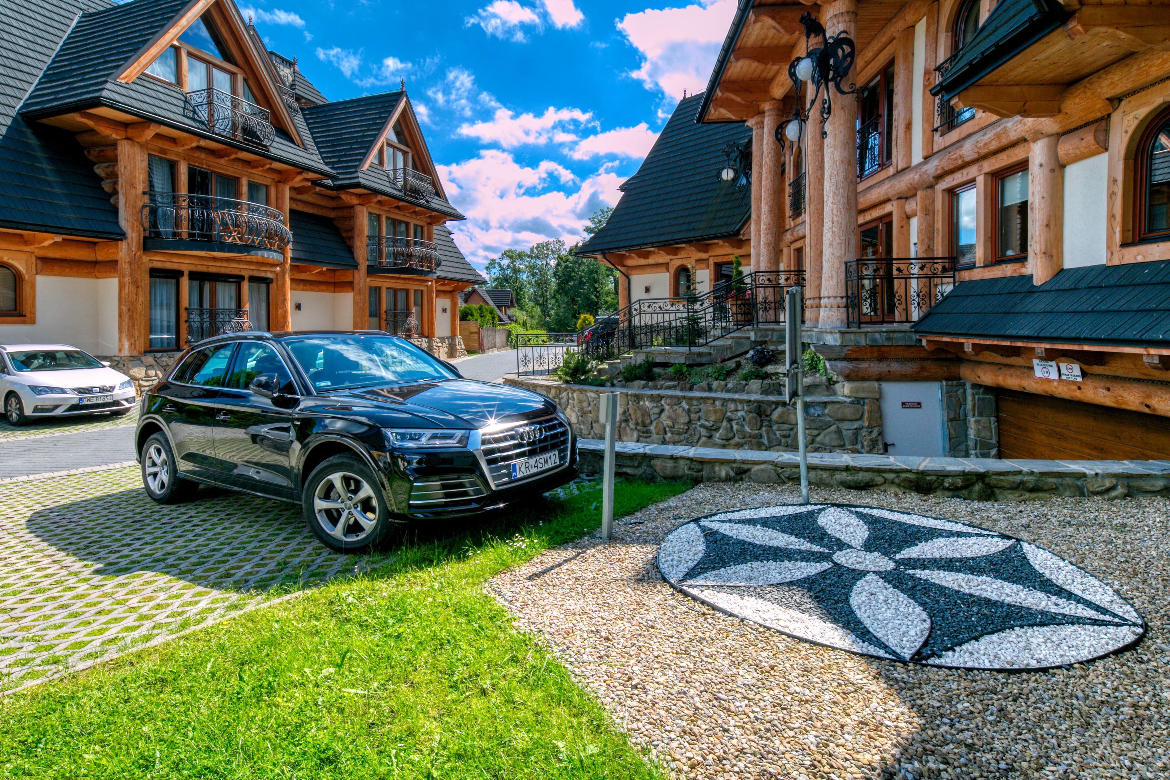 A modern building with a car parked in front.