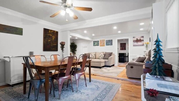 A spacious living room with a dining area, a sofa set, and a decorative tree. - Sixth Street Victorian — Downtown Leadville (Leadville)