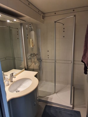 Shower, hair dryer, towels, toilet paper