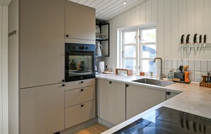 Fridge, stovetop, dishwasher, coffee/tea maker