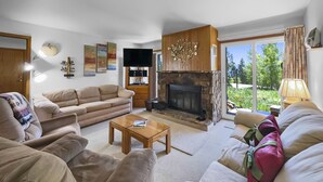A living room with a fireplace, a sofa, a coffee table, and a television. - Bb103 Buffalo Ge 2br 2ba 2 Bedroom Condo by RedAwning (Silverthorne)