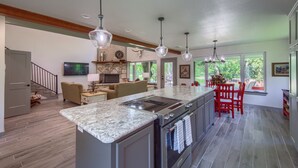 A spacious kitchen with a large island, modern appliances, and pendant lighting. - Down River Haus Ld 727 3 Bedroom Home by RedAwning (New Braunfels)