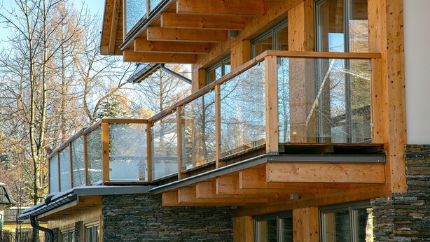 A modern building with large windows and wooden balconies. - Apartament with Hot Tub (Zakopane)