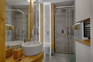 A modern bathroom with two sinks, a bathtub, a toilet, and a glass-enclosed shower. - Apartament with Hot Tub (Zakopane)