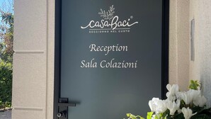 A reception door with "casaBaci" branding and "Reception Sala Colazioni" signage. - Casa Baci (Lazise)
