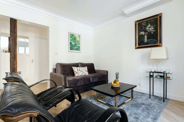 The large living room has a large sofa and several armchairs