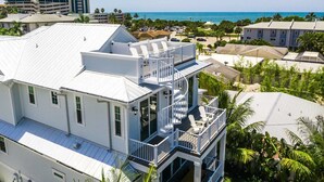 A multi-story building with a balcony and a view of the ocean. - Putting green, Rooftop Deck AND Beach/Gulf Views with Private Heated Pool/Spa. (Lido Key)