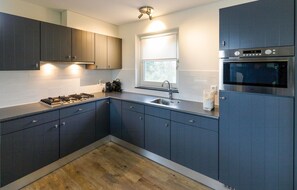 Fridge, stovetop, dishwasher, coffee/tea maker