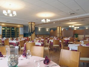 Enjoy dining in this stylish space with comfortable seating and elegant table settings.