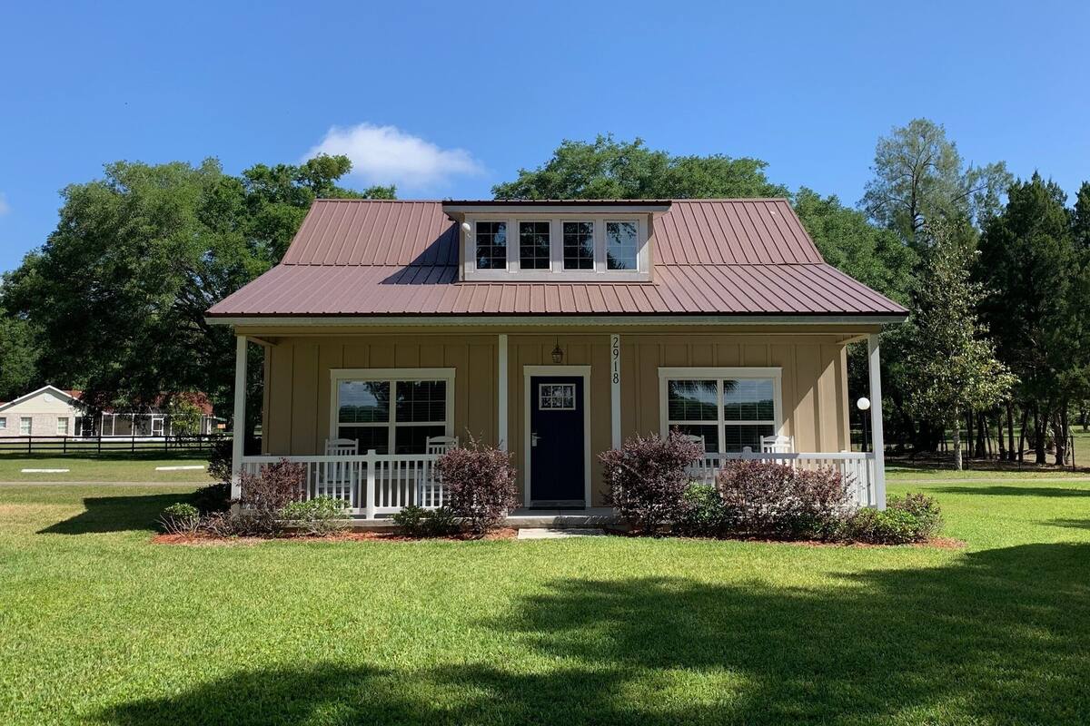 A single-story house with a front porch, a small attached garage, and a number '2918' on the front door.