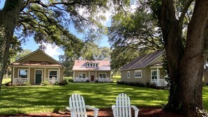 A property with two single-story houses, each with a porch and a small front yard. - Grand Oaks Resort (Lady Lake)