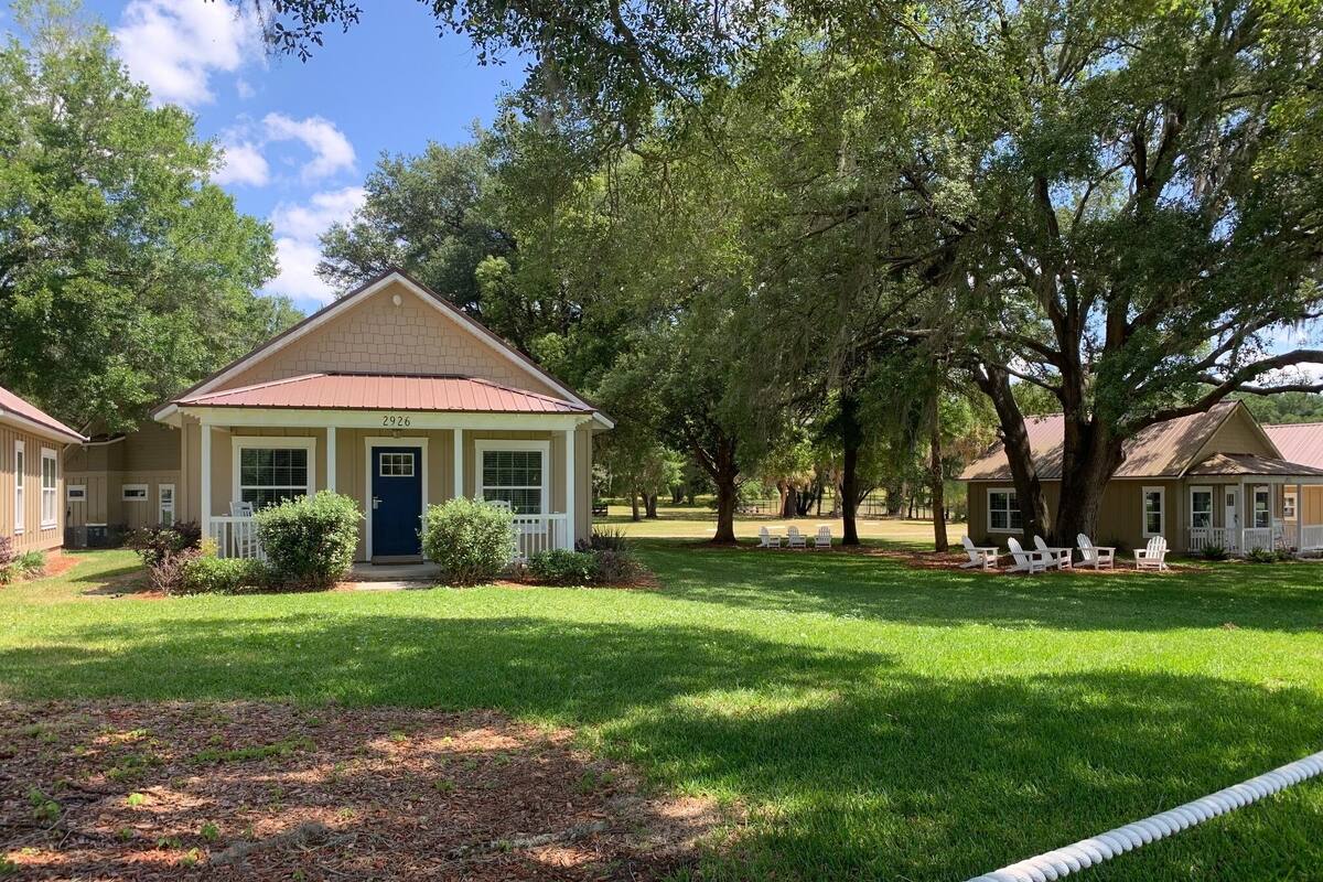 A two-story house with a front porch, a mailbox, and a well-maintained lawn.