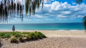 A beach with a 'No Dogs Allowed' sign, clear skies, and calm waters. - FAMILY BEACH HOLIDAY HOUSE (WOORIM)