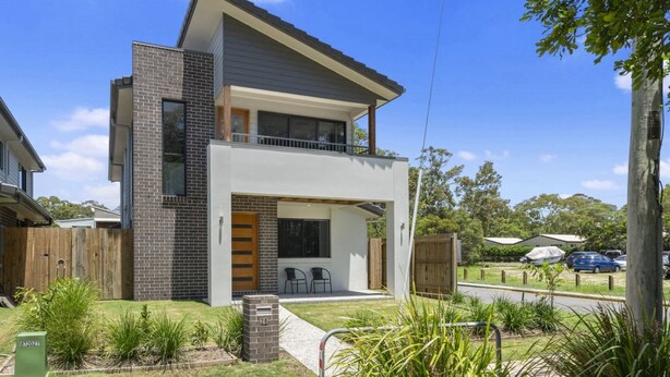 A modern two-story house with a balcony, a covered patio, and a well-maintained garden. - FAMILY BEACH HOLIDAY HOUSE (WOORIM)