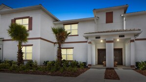 A two-story building with a white exterior and brown trim, featuring a number '1578' on the facade.