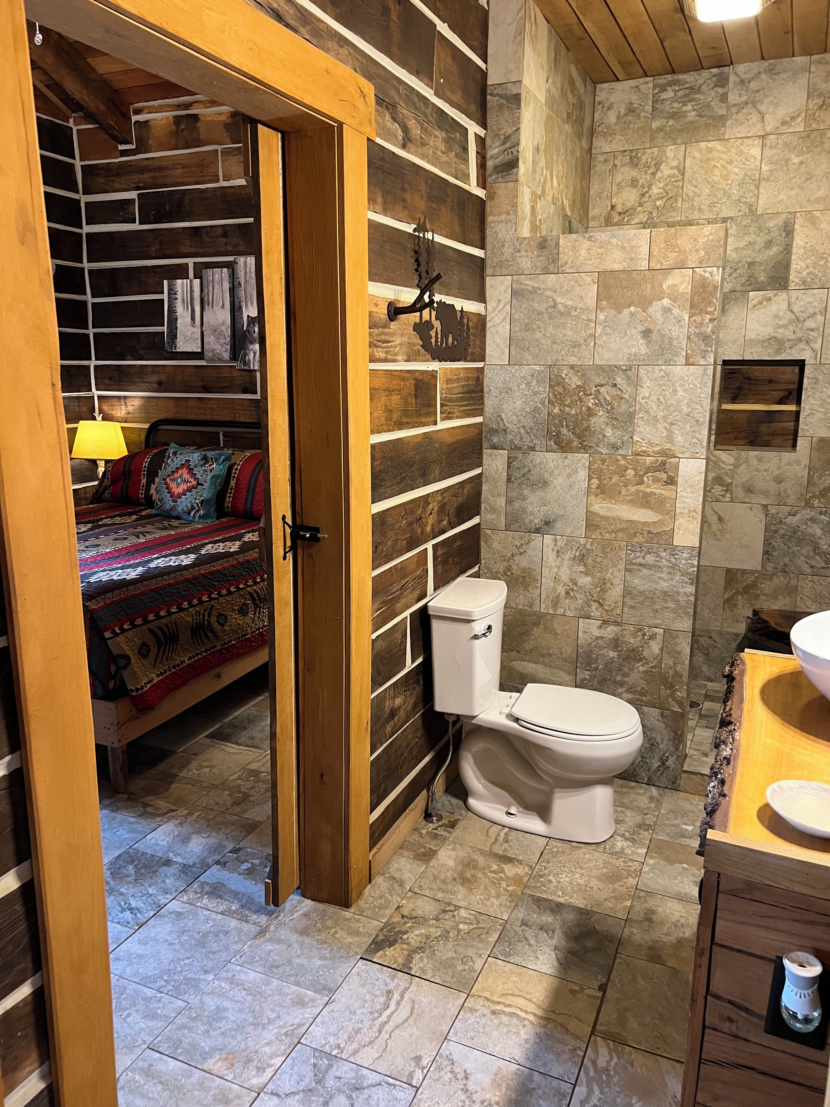 A bathroom with a toilet, sink, and shower area.