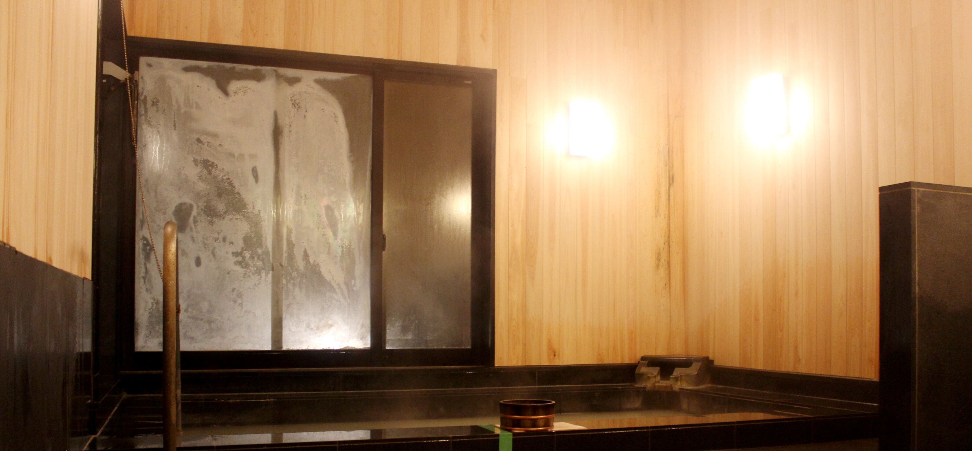 A traditional Japanese room with tatami flooring, a shoji screen, and a low table with a candle.