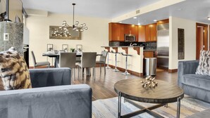 A modern kitchen with stainless steel appliances, wooden cabinets, and a bar area. - Luxury Ski-In/Out at Park City Mtn-Pool/Hot Tub I Managed by Park City Lodging (Park City)