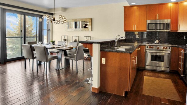 A modern kitchen with wooden cabinets, a built-in microwave, and a Wolf oven. - Luxury Ski-In/Out at Park City Mtn-Pool/Hot Tub I Managed by Park City Lodging (Park City)