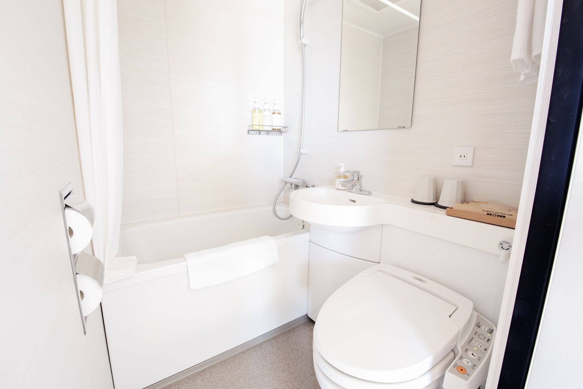 A modern bathroom with a toilet, sink, and shower.
