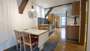 A modern kitchen with wooden cabinets, a built-in oven, and a coffee maker. - City Center Luxury Getaway (Sønderborg)