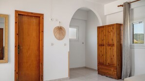 A room with a wooden door, a wardrobe, a mirror, and a window with curtains. - Dora Pool Studios by Konnect, 150m from the Beach (Corfu)