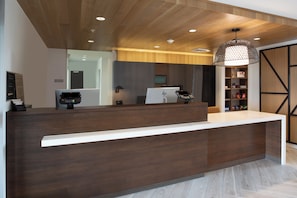 A reception desk with a modern design, equipped with a digital payment terminal and a traditional cash register. - Staybridge Suites Carson City - Tahoe Area by IHG (Carson City)