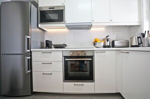 Enjoy cooking in this fully equipped kitchen with a refrigerator, oven, and microwave.