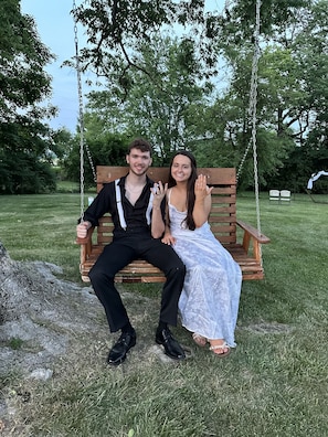 A wooden swing set in a grassy area with trees in the background. - Hagen Homestead, Quiet, serene farmhouse, close to everything! (Oxford)