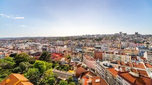 Un paisaje urbano con edificios muy juntos, una variedad de estilos arquitectónicos y un cielo despejado.
