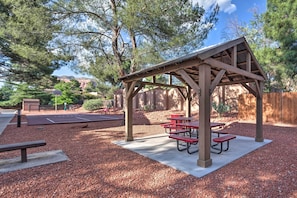 Enjoy outdoor dining or relaxation in this serene picnic area with picnic tables and benches.