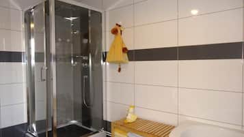 Combined shower/bathtub, hair dryer, towels, toilet paper