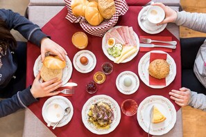 A table set with various breakfast items including bread, eggs, and pastries. - Hieserhof (Neustift Im Stubaital)