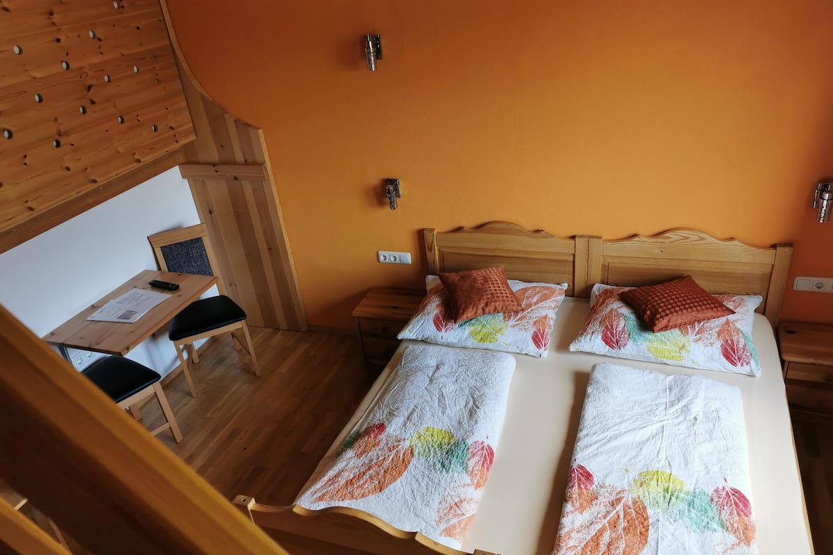 A room with a bed, a desk, and a chair.