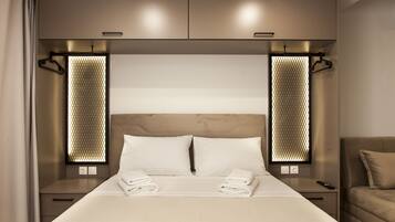 A neatly made bed with white linens, a headboard, and two bedside tables with lamps.