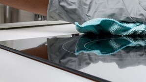 A hand cleaning a reflective surface with a cloth. - Tudors eSuites Apartment with 4 Beds (Birmingham)