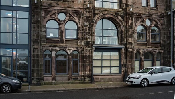 A historic stone building with large arched windows and a prominent central entrance. - Stunning harbour side Gold graded apartment for two with secure parking (Berwick upon Tweed)