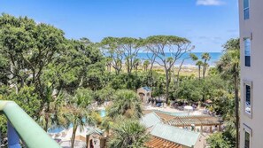 A resort with a pool, palm trees, and a view of the beach. - Oceanfront Luxury Villa w/ Pool on Hilton Head (Hilton Head Island)