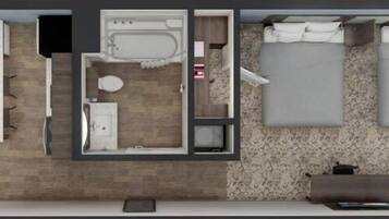 A hotel room with a large bed, a separate bathroom, a desk with a chair, and a small seating area.
