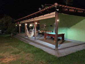 Relax by the pool table and hammock under a covered pergola.
