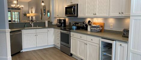 Fridge, microwave, coffee/tea maker, cookware/dishes/utensils