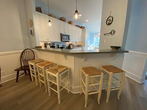 Fridge, microwave, coffee/tea maker, cookware/dishes/utensils