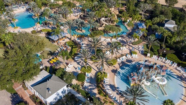 An aerial view of a resort with multiple swimming pools, palm trees, and lounge areas. - Games Room | Theater Room | Kids Themed Bedrooms | Private Pool (Kissimmee)