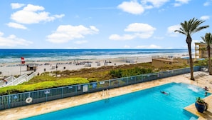 A pool area with a view of the beach and ocean. - Sterling Breeze 203 (Panama City Beach)