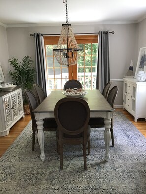 Enjoy meals in this elegant dining room with a long table and comfortable seating for six.