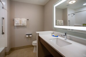 A modern bathroom with a white sink, a large mirror, and a shower area. - Holiday Inn Express & Suites Deland South by IHG (DeLand)