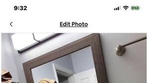 A bathroom with a granite countertop sink, a mirror, and towels hanging on a rack. - Comfort Zone Palace Inn (Jacksonville)