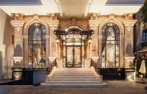 A grand entrance with a staircase leading to a door labeled "DOLCE HOTEL." - D'Lecia Ha Long (Bai Chay)